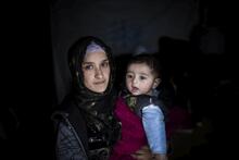 Hakima, 21, holds her four-month-old baby, Jad, at Bar Elias refugee settlement in Lebanon. She fled Syria five years ago and is living with her husband at her brother-in-law’s house, after the one they had been living in was flooded. 
