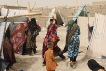 Women walk among makeshift tents in a camp for internally displaced people in Mazar-e Sharif city in northern Afghanistan.