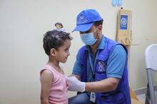 A doctor examines a young patient at the Abdulqaway health centre in Aden city, Yemen, 18 March 2020.
